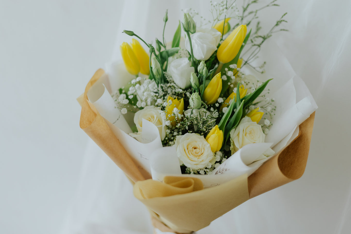 Sunlit Elegance: Yellow Tulips & White Flower Bunch