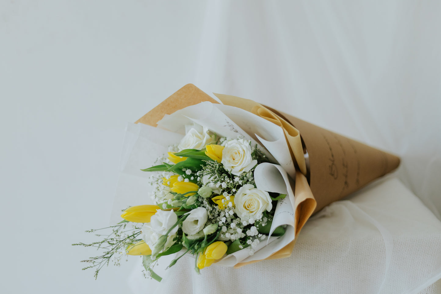 Sunlit Elegance: Yellow Tulips & White Flower Bunch