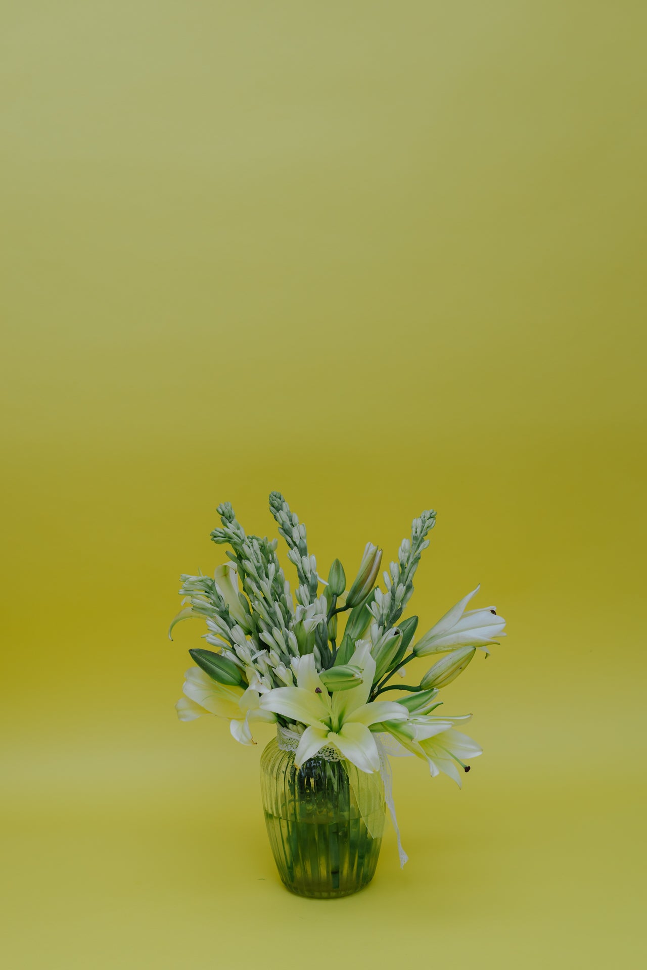 Ivory Fushion in Vase: Lilies and Rajnigandha
