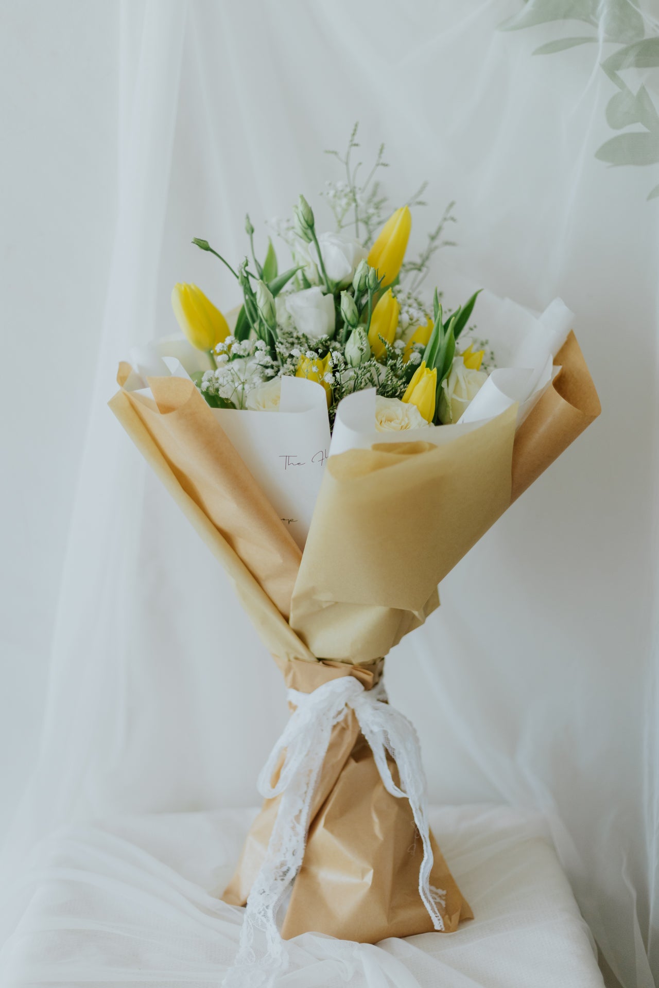 Sunlit Elegance: Yellow Tulips & White Flower Bunch