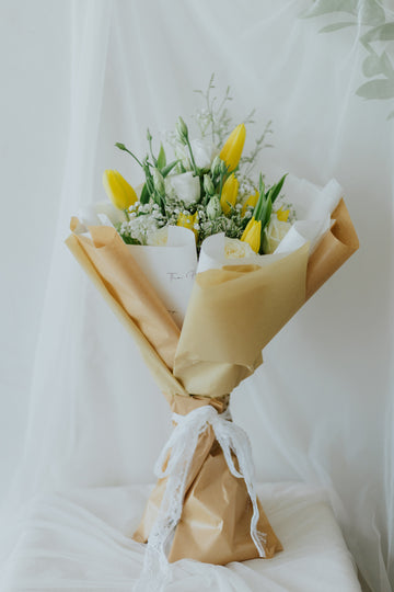 Sunlit Elegance: Yellow Tulips & White Flower Bunch