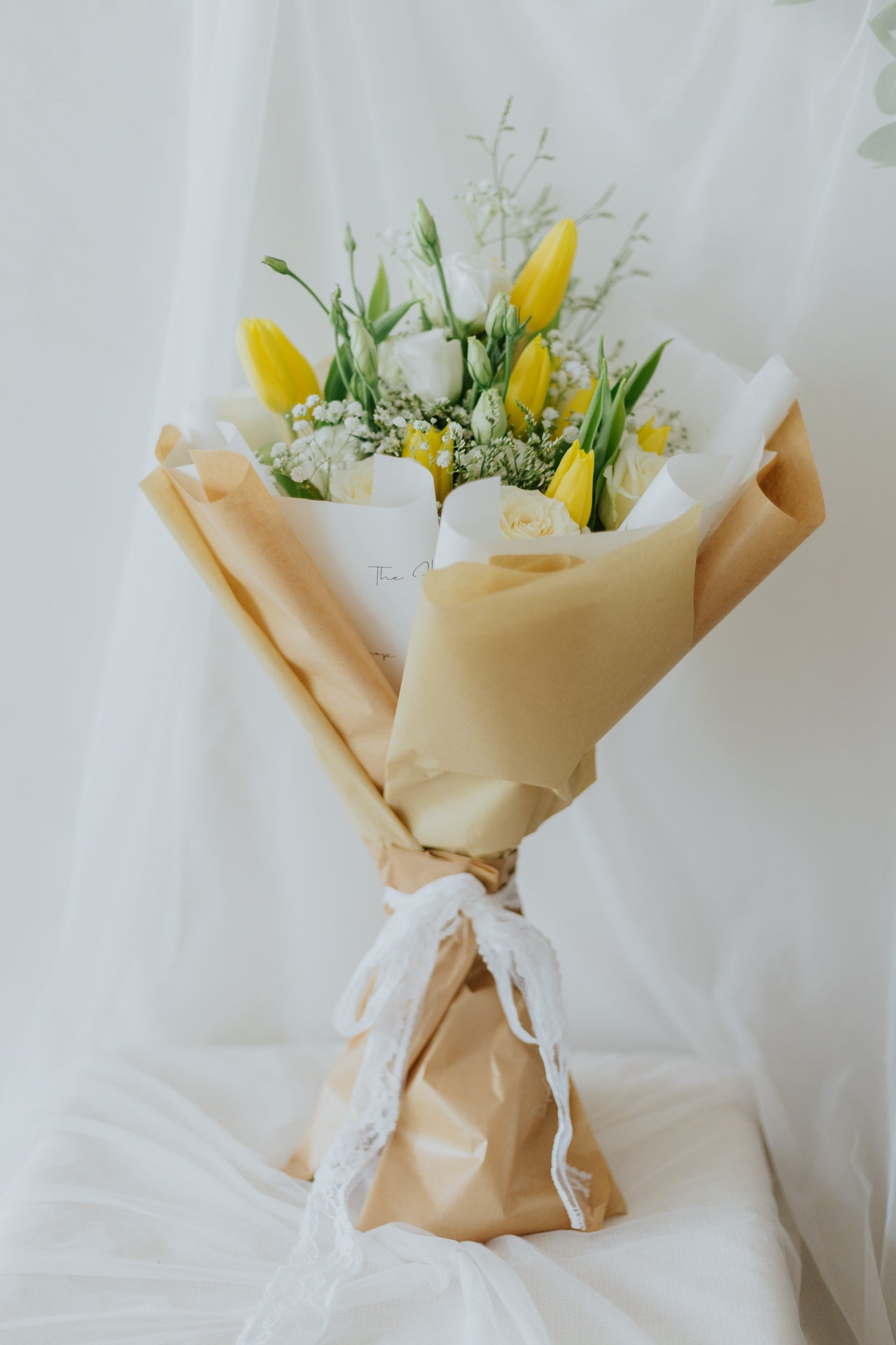 Sunlit Elegance: Yellow Tulips & White Flower Bunch