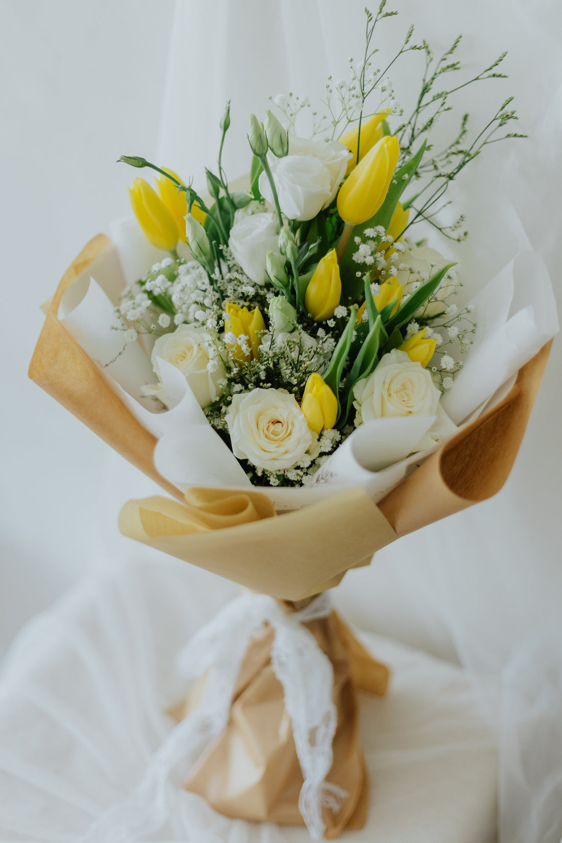 Sunlit Elegance: Yellow Tulips & White Flower Bunch