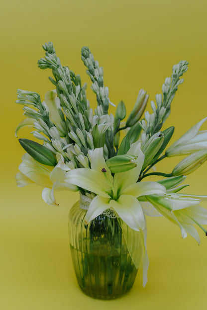 Ivory Fushion in Vase: Lilies and Rajnigandha