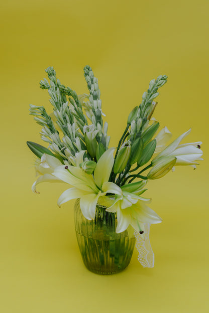 Ivory Fushion in Vase: Lilies and Rajnigandha